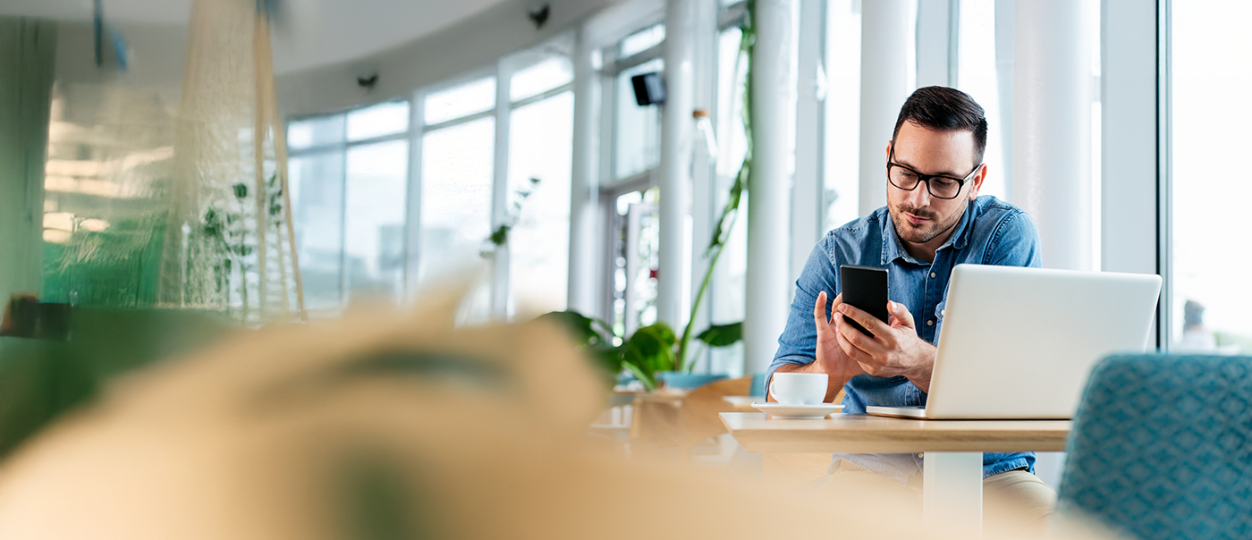 Man in an office building using his phone to contact an orthodontic office in Round Rock