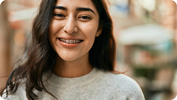 Young woman with braces smiling