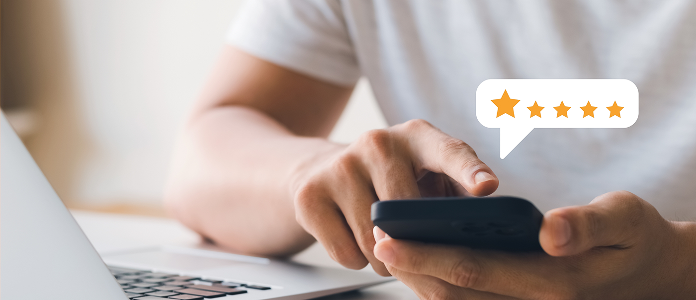 Person leaving a five star review on their phone