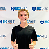 Teenage boy giving two thumbs up