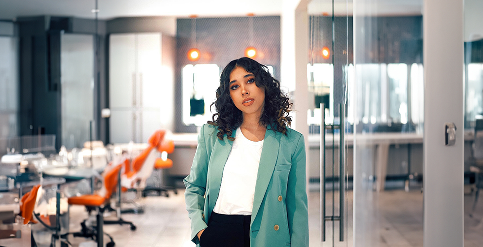 Woman in business casual attire in an open office